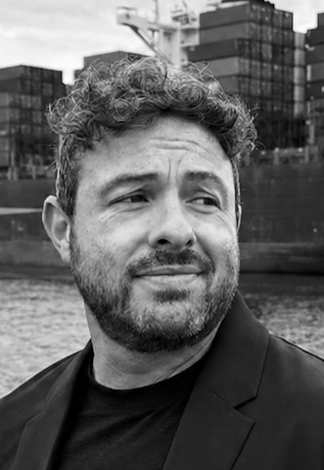 Portrait of Mike Norton, founder and CEO of Western Container Sales, with a container ship in the background.